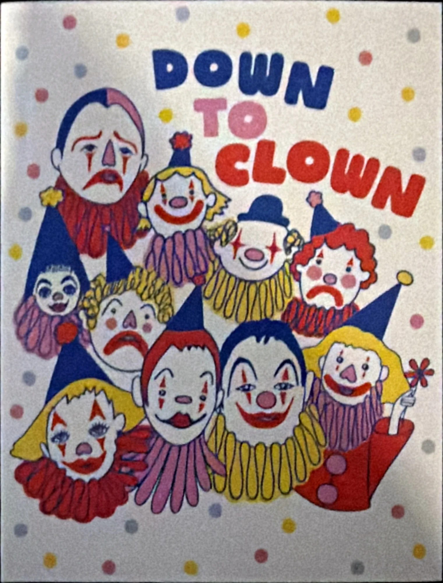 Illustrated card of ten clown faces in ruffled collars under the words Down to Clown, on a polka-dot ground.
