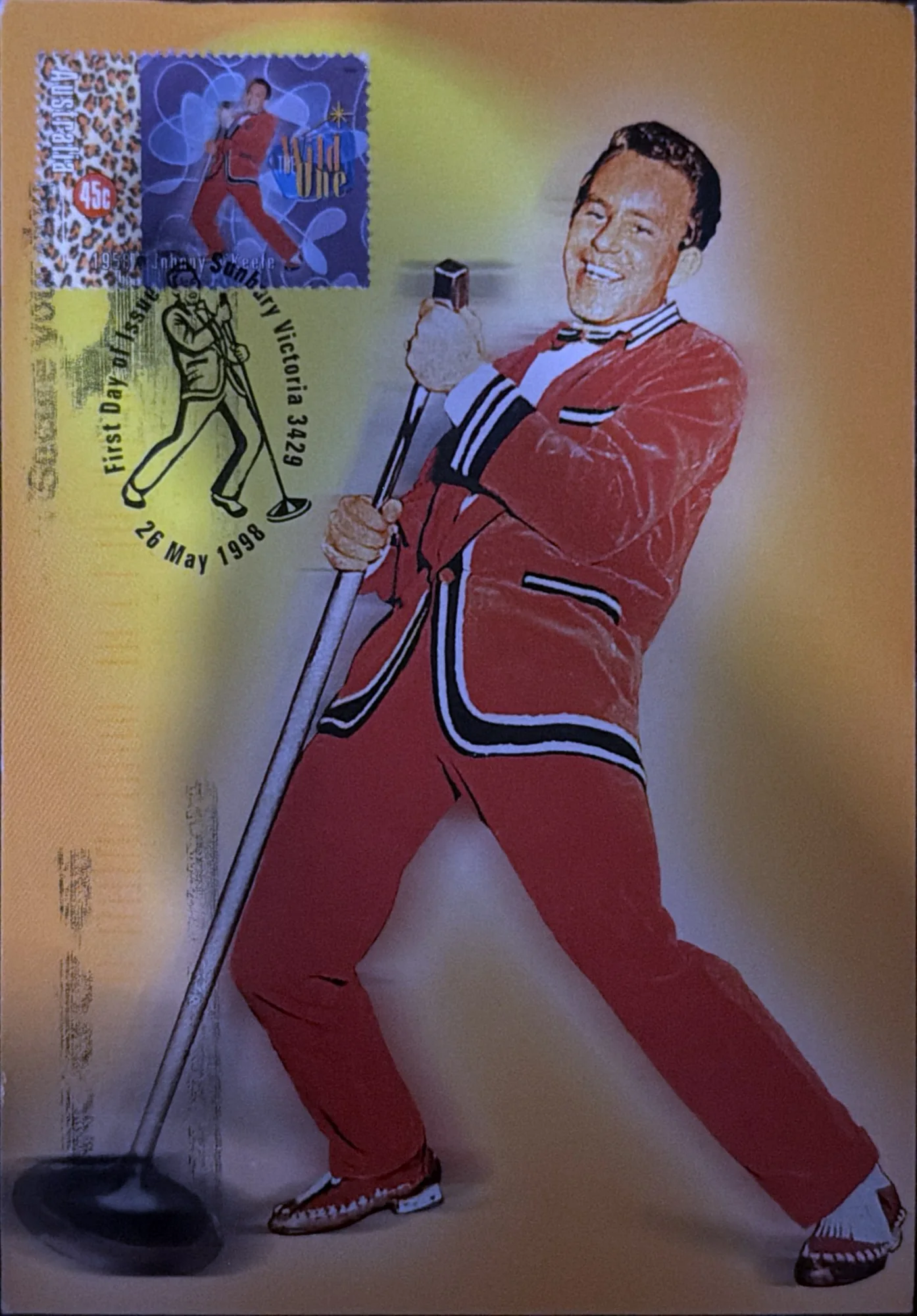 Illustration of a singer in a red suit gripping a microphone stand, with a matching stamp and a pictorial first-day cancel in the corner.