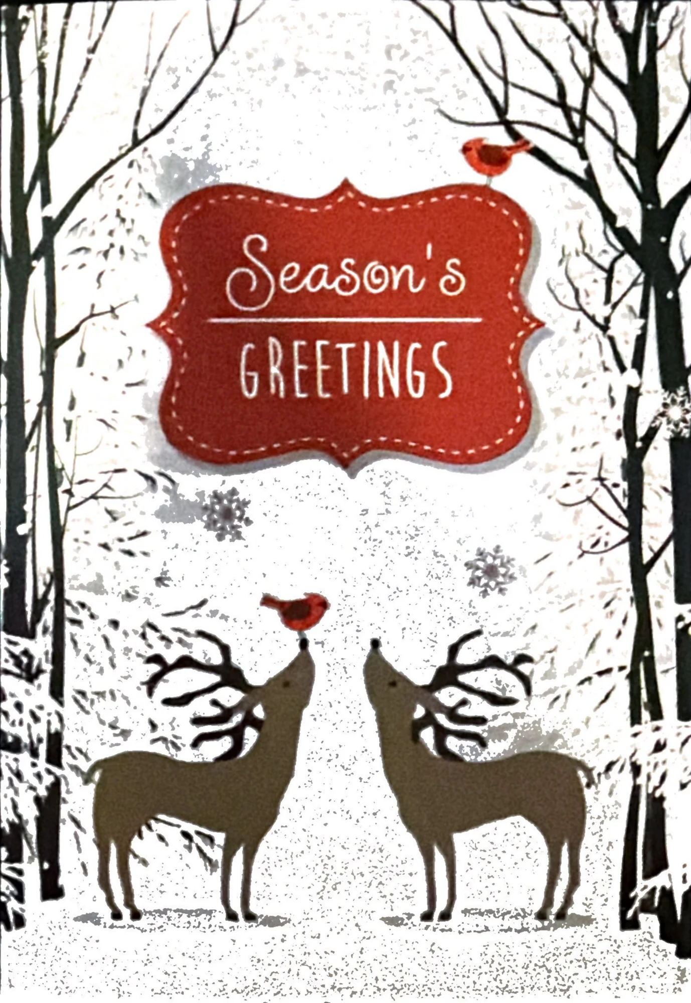 Two silhouetted deer under a red Season's Greetings sign, with cardinals, bare trees and snow.